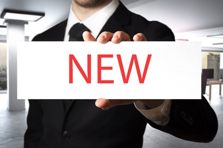 businessman in office holding sign newの写真素材