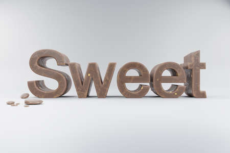 closeup of 3d lettering sweet made of brown whole milk chocolate on clean surface with chocolate crumbs; advertisement concept; 3D Illustrationの写真素材