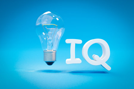 single glass lightbulb filament wire floating in the air over infinite blue background; white lettering iq; 3D Illustrationの写真素材