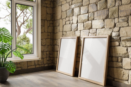 two empty canvas poster mock up leaning on wall; bright daylight shining through large window; home...