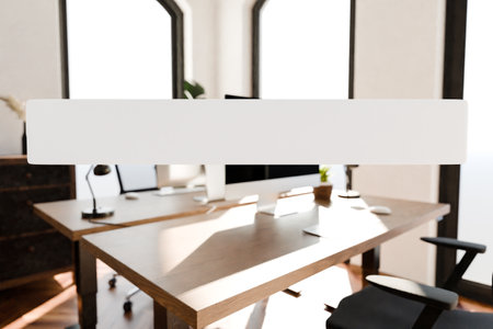 transparent text box in front of modern minimalistic pc workspace in luxurious office and panoramic view; remote work home office concept; bright daylight; 3D renderingの写真素材