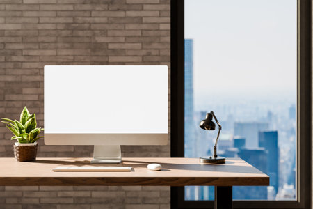 frontal view on modern clean pc workplace; white monitor with copy space; minimalist office background with panoramic view on big city skyline; digital home concept; 3D renderingの写真素材