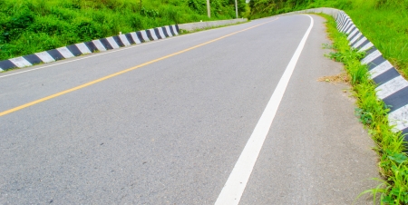 curved road to the left on the hillの写真素材