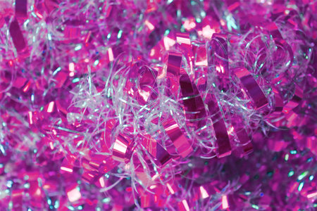 Photo by pink and white tinsel to background. Close-up.