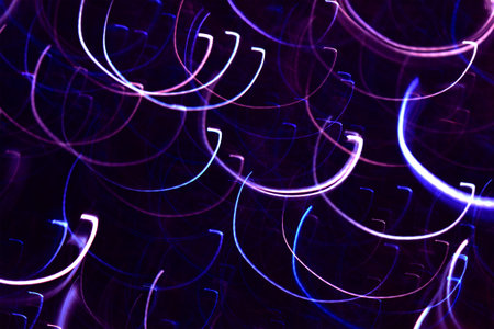 Photo by pink, violet,blue and white  semi-oval light lines to abstract background.