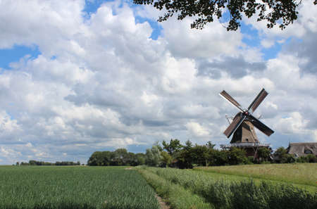 PAESENS, NETHERLANDS, 21 JULY 2020: View of Windmill, (Molen de Hond), a well known landmark near Paesens in Friesland. It is a restored working windmill still used to grind flour today.のeditorial素材