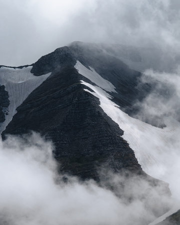 Snow on top of the mountain, beautiful photography of the foggy sky and winter mountains. Outdoor...