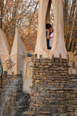 a couple kissing in a tower of a small castle.の写真素材