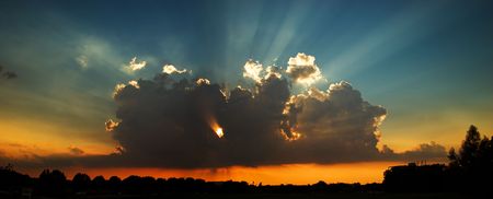 a pinhole through the clouds during a sunset.の写真素材