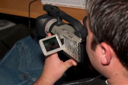 a guy reviewing video footage on a camera.