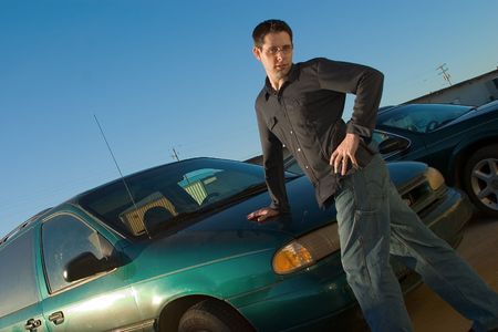 a funny guy posing seductively on a minivan.の写真素材