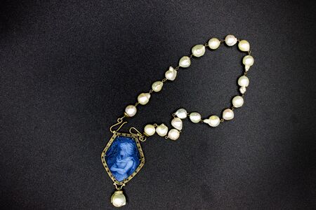 Naples Italy. Pearl necklace with coral pendant also called cameo, depicting a stately woman.の写真素材