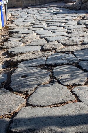 Bacoli, Naples 08 August 2019. In the ancient city of Cuma, the pavement of the streets is still intact, there are signs of passages on the stones.の写真素材