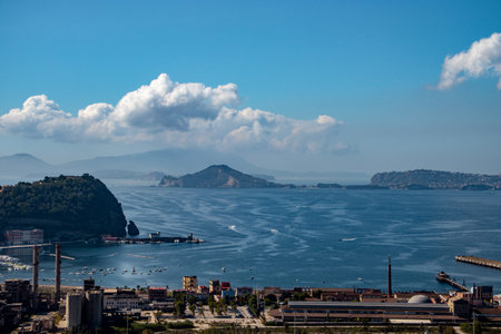 Naples, panorama of the Gulf of Naples with seagulls flying over the sea. In the background the mountain of Miseno.の写真素材