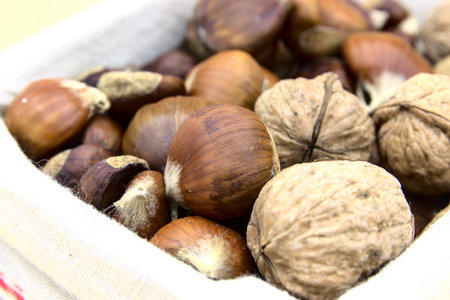 In the foreground the chestnuts and walnuts, typical fruit of the Christmas periodの写真素材