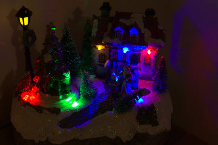 The representation of a Santa Claus Village. With colored lights and snowy trees.の写真素材