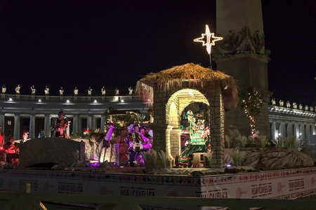 Piazza San Pietro, the nativity scene, and the Christmas tree decorated with gold-colored lightsの写真素材