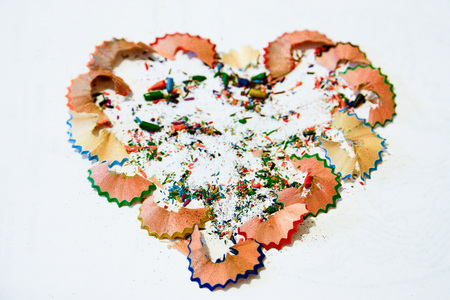 Colorful heart sharpen of pencils. School pencils sharpen the matire creates a heart. Conceptual image of heart of pencilsの写真素材