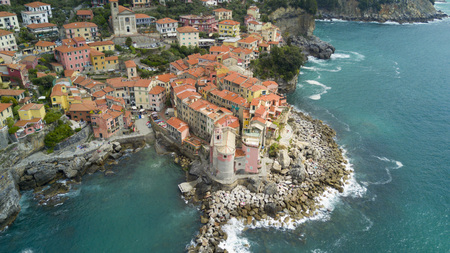 Aerial shooting with drone on Tellaro, famous Ligurian village near the Cinqueterre, small colored houses built on the cliff by the seaの写真素材