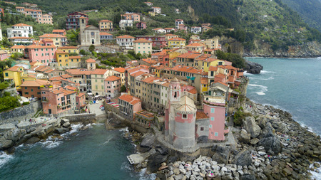Aerial shooting with drone on Tellaro, famous Ligurian village near the Cinqueterre, small colored houses built on the cliff by the seaの写真素材