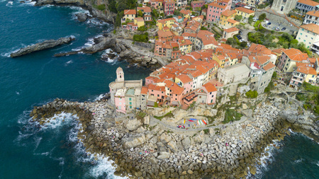 Aerial shooting with drone on Tellaro, famous Ligurian village near the Cinqueterre, small colored houses built on the cliff by the seaの写真素材