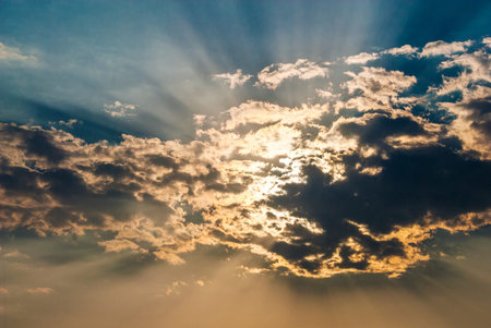 The light of the sun at sunset filtered by a huge cloud