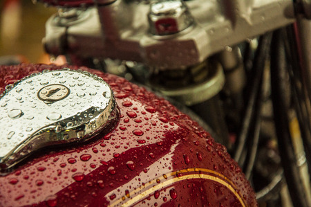 Many drops of water on a red surface of a motorbikeの写真素材