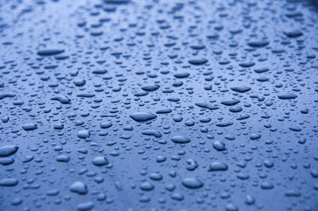 Many drops of water on a  blue surfaceの写真素材
