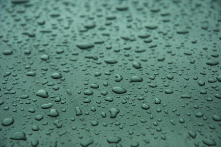 Many drops of water on a grey surfaceの写真素材