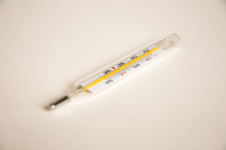 a photo of a thermometer closeup on a light backgroundの写真素材