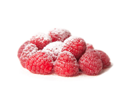 group of beautiful red raspberries with a sugar powder on a white background