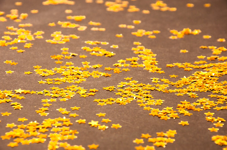Golden small Stars on a dark backgroundの写真素材