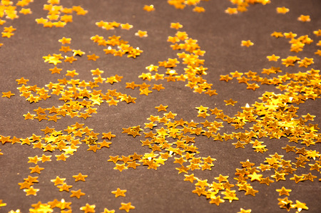 Golden small Stars on a dark backgroundの写真素材