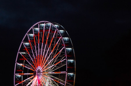 Bright ferris wheel at nightの写真素材