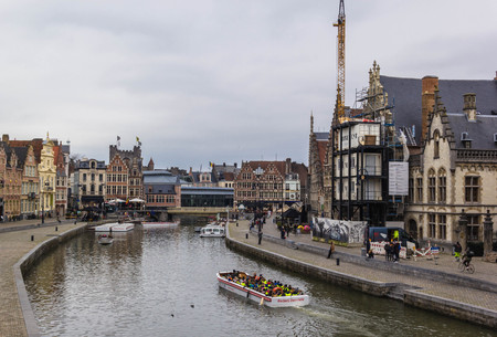GHENT, BELGIUM - MARCH 23 2018: Tourists at the Leie riverbank in the central of Ghent on March 23,2018 in Ghent, Belgiumのeditorial素材
