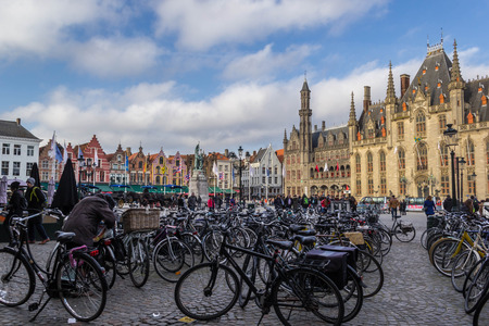 BRUGES, BELGIUM - MARCH 23 2018: Bicycles parking at Market Square in the center of Bruges on March 23,2018 in Bruges, Belgiumのeditorial素材