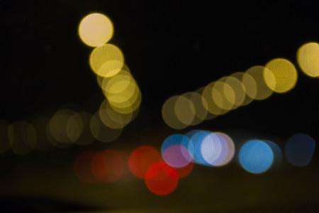 Colorful light bokeh on blurred night backgroundの写真素材