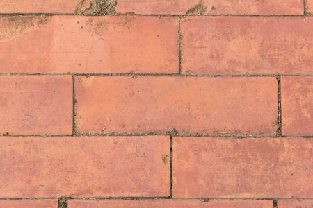 Close-up orange rough brick floor background