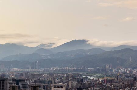 View of Taipei city with range of mountains backgroundの写真素材