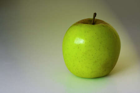 Picture of an apple on a coloured backgroundの写真素材
