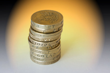 Stack of British Pound Coins on a coloured background