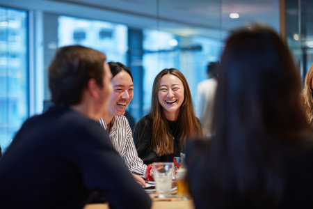 A candid shot of team members laughing during meeting, showcasing joy and collaborationの素材
