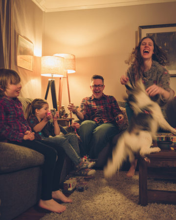 A family enjoying game night with laughter and playful dogの素材
