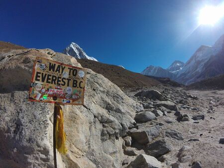 Gorak Shep, Nepal - May 15th, 2019: Signpost way to mount Everest Base Cam and Himalayan panoramaのeditorial素材