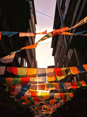 Kathmandu, Nepal - May 20th 2019: Tibetan prayer flags line the sky between buildings in Kathmandu's tourist district Thamelのeditorial素材