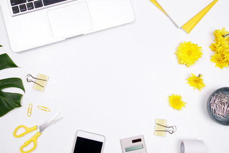 Woman workspace with laptop, handwritten quote notebook, yellow flower and smartphone on white background. Flat lay, top view. stylish female blogger concept. spring summer background.の写真素材
