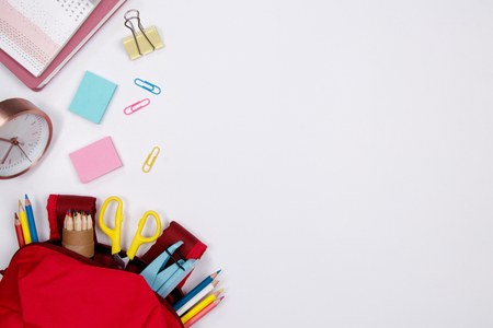 Stationeries and office supplies on white background. Flat lay. Top view with copy space. Back to school concept.の写真素材