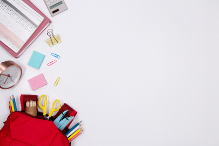 Stationeries and office supplies on white background. Flat lay. Top view with copy space. Back to school concept.の写真素材