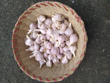 Fresh garlic in wooden basket top view