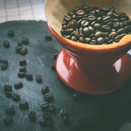 Coffee beans in coffee drip cone vintage colorの写真素材